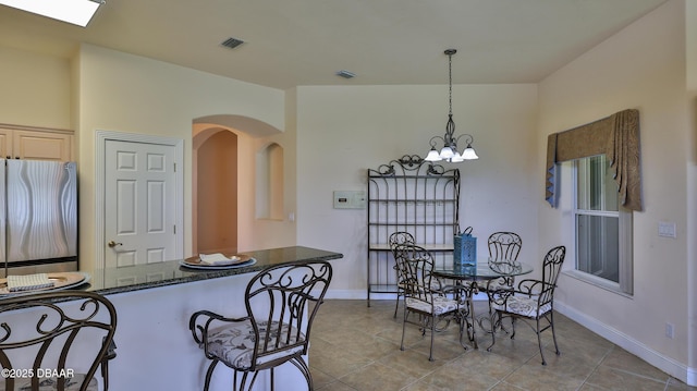 4269 Mayfair Ln, Port Orange, FL 32129 - tiled dining area with arched walkways and a chandelier