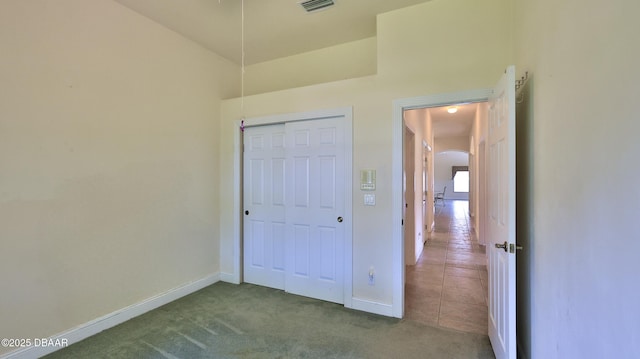4269 Mayfair Ln, Port Orange, FL 32129 - unfurnished bedroom with arched walkways, carpet flooring, and a closet
