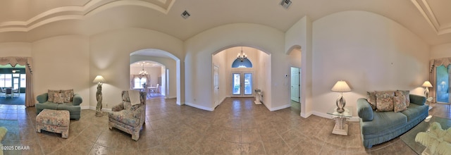 4269 Mayfair Ln, Port Orange, FL 32129 - foyer entrance featuring arched walkways, french doors, and a chandelier