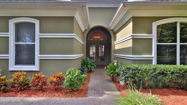 4269 Mayfair Ln, Port Orange, FL 32129 - view of exterior entry featuring french doors and roof with shingles