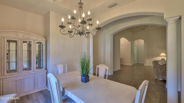 4269 Mayfair Ln, Port Orange, FL 32129 - dining room with arched walkways, a chandelier, and dark tile patterned flooring