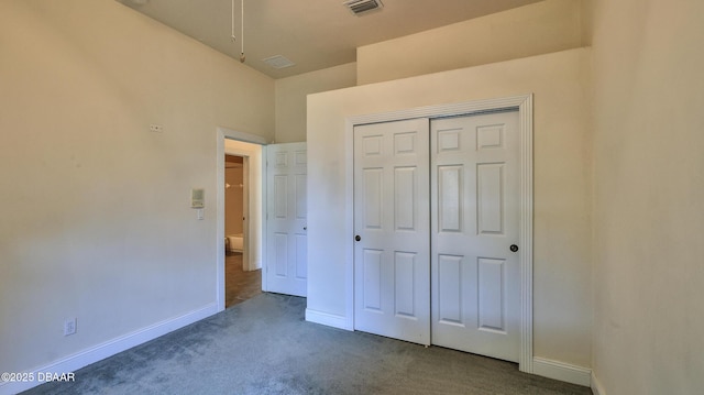 4269 Mayfair Ln, Port Orange, FL 32129 - unfurnished bedroom with dark carpet, attic access, and a closet