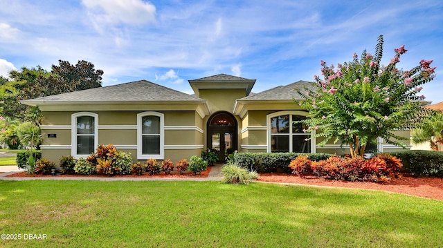 4269 Mayfair Ln, Port Orange, FL 32129 - view of front of house with a front lawn, stucco siding, and a shingled roof