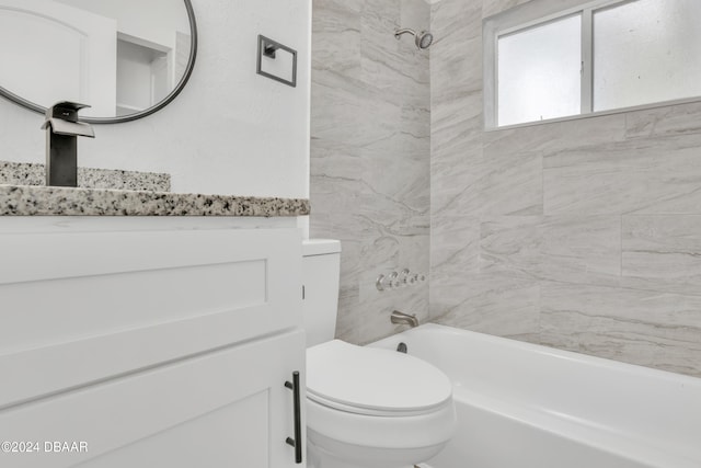 bathroom featuring tiled shower / bath and toilet