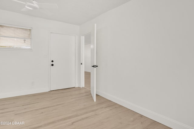 unfurnished room featuring ceiling fan and light wood-type flooring