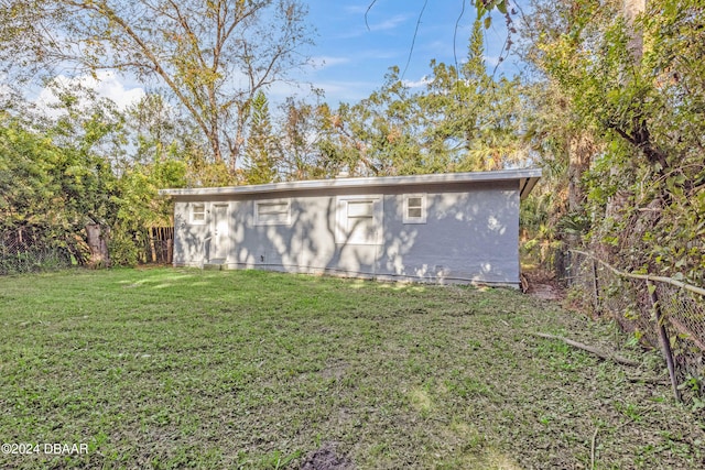 view of outbuilding featuring a yard