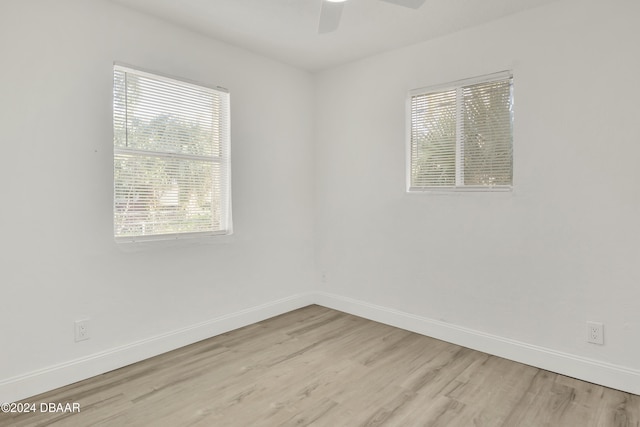 spare room featuring ceiling fan and light hardwood / wood-style flooring