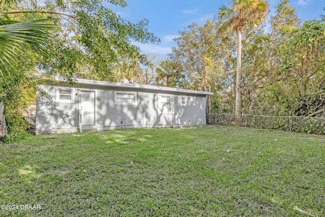 view of outbuilding with a lawn