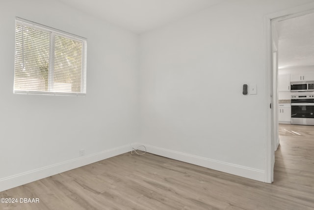 unfurnished room with light hardwood / wood-style floors