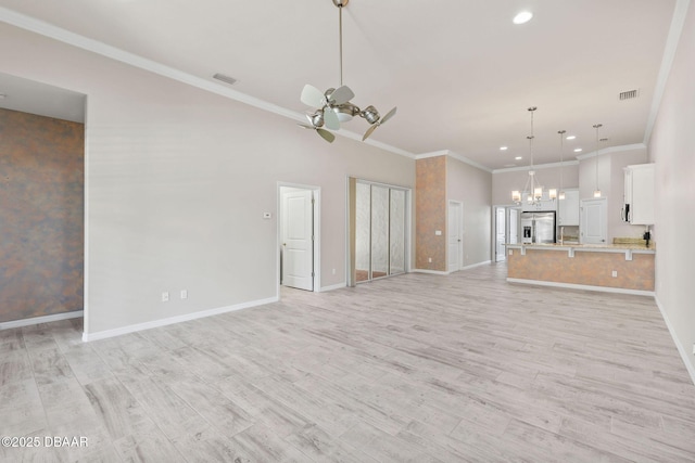 3402 Torre Blvd, New Smyrna Beach, FL 32168 - unfurnished living room with a chandelier, baseboards, ceiling fan, light wood-style floors, and crown molding