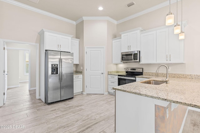 3402 Torre Blvd, New Smyrna Beach, FL 32168 - kitchen featuring stainless steel appliances, a sink, a peninsula, ornamental molding, and light stone counters