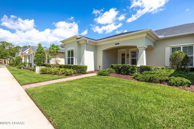 3402 Torre Blvd, New Smyrna Beach, FL 32168 - view of front of home with stucco siding and a front lawn