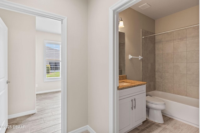 3402 Torre Blvd, New Smyrna Beach, FL 32168 - bathroom featuring wood finished floors, toilet, vanity, and shower / bath combination