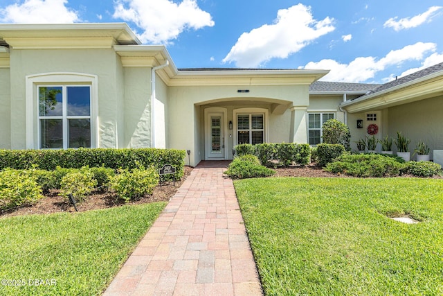 3402 Torre Blvd, New Smyrna Beach, FL 32168 - entrance to property with stucco siding and a yard