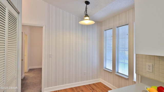 156 Grand Oaks Cir, Daytona Beach, FL 32114 - unfurnished dining area featuring a textured ceiling and light wood-type flooring