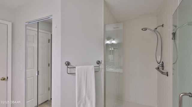156 Grand Oaks Cir, Daytona Beach, FL 32114 - full bathroom with a shower stall, a textured ceiling, and a closet
