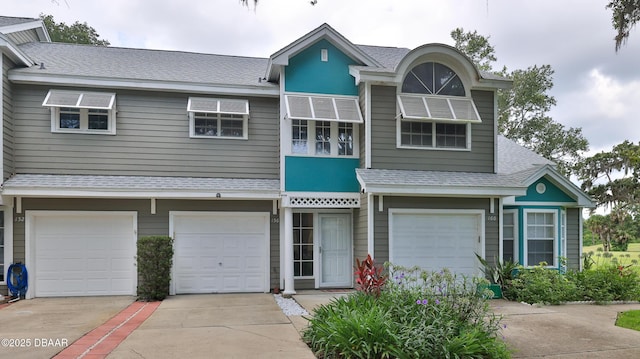156 Grand Oaks Cir, Daytona Beach, FL 32114 - view of front facade featuring driveway, an attached garage, and a shingled roof