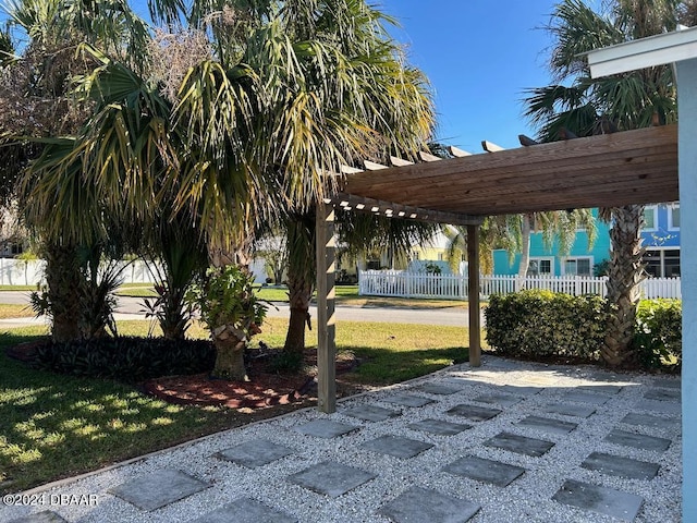 view of home's community featuring a pergola and a yard