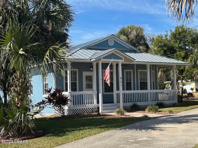 view of front of house with a front yard and a porch