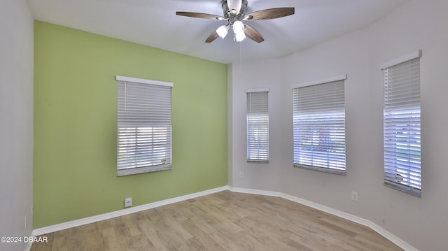 spare room with ceiling fan, light hardwood / wood-style floors, and a wealth of natural light