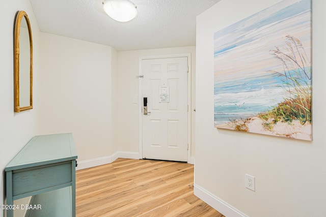 interior space with light hardwood / wood-style floors and a textured ceiling