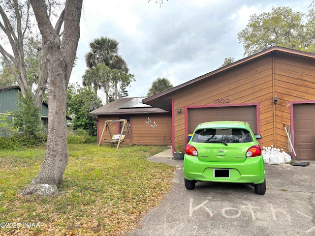 view of front of house with a garage and roof mounted solar panels