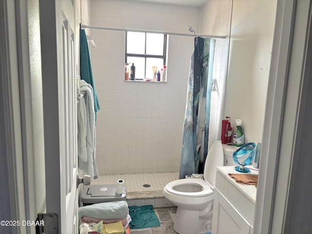 bathroom with vanity, a shower stall, and toilet