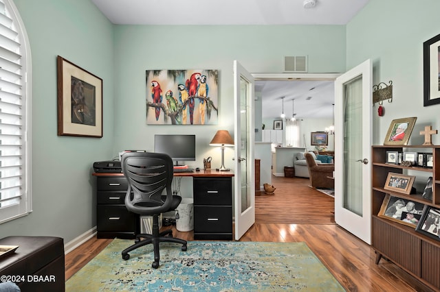 office featuring hardwood / wood-style floors, a chandelier, and french doors