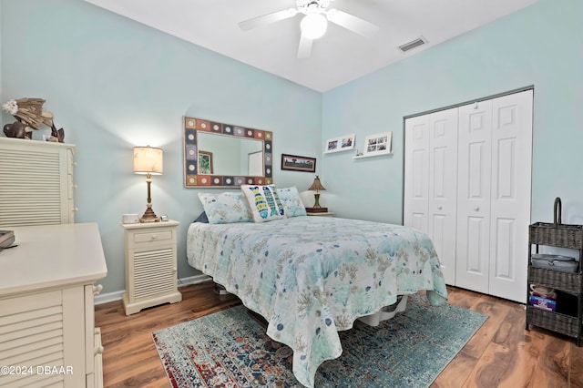 bedroom featuring hardwood / wood-style floors, ceiling fan, and a closet