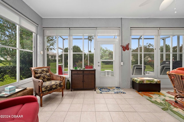 sunroom / solarium featuring a wealth of natural light and ceiling fan