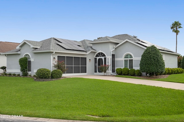 single story home with solar panels and a front lawn