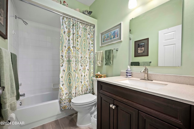 full bathroom with wood-type flooring, shower / bath combo with shower curtain, toilet, and vanity