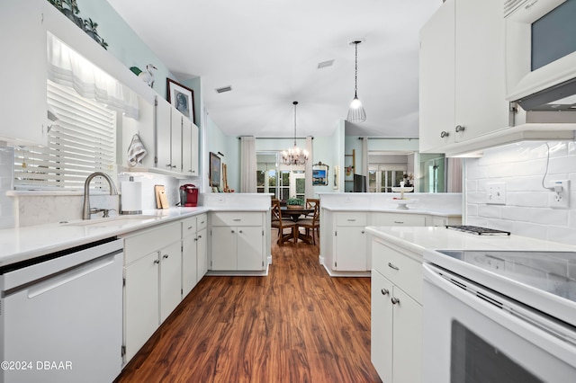 kitchen featuring white cabinets, a chandelier, sink, white appliances, and decorative light fixtures