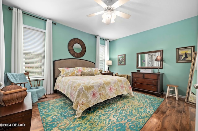 bedroom with ceiling fan and dark hardwood / wood-style floors