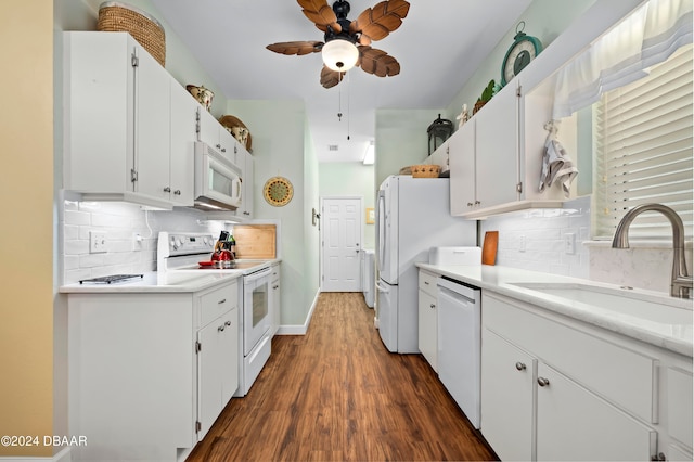 kitchen with sink, dark hardwood / wood-style floors, white appliances, white cabinets, and decorative backsplash