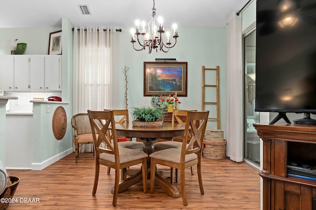 dining area with a chandelier and light hardwood / wood-style floors