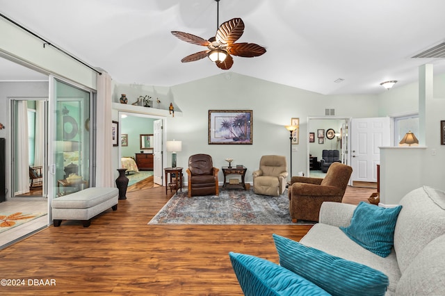 living room with lofted ceiling, hardwood / wood-style flooring, and ceiling fan