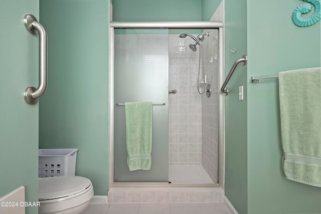 bathroom featuring walk in shower, toilet, and tile patterned flooring