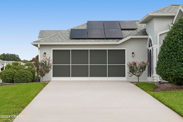 view of front of property with solar panels and a front lawn