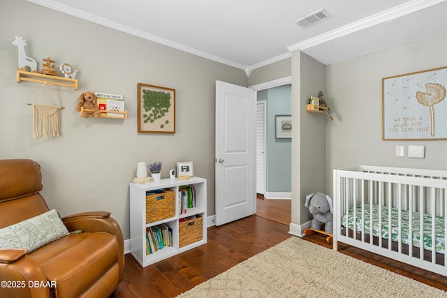 1245 Thomas Dr, Port Orange, FL 32129 - bedroom with visible vents, baseboards, ornamental molding, a crib, and wood finished floors