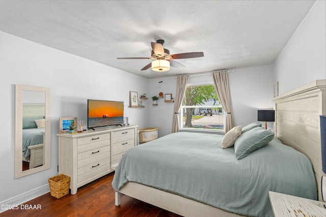 1245 Thomas Dr, Port Orange, FL 32129 - bedroom with baseboards, a ceiling fan, and dark wood-style flooring