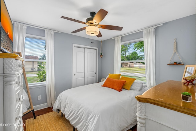 1245 Thomas Dr, Port Orange, FL 32129 - bedroom with baseboards, wood finished floors, ceiling fan, and a closet