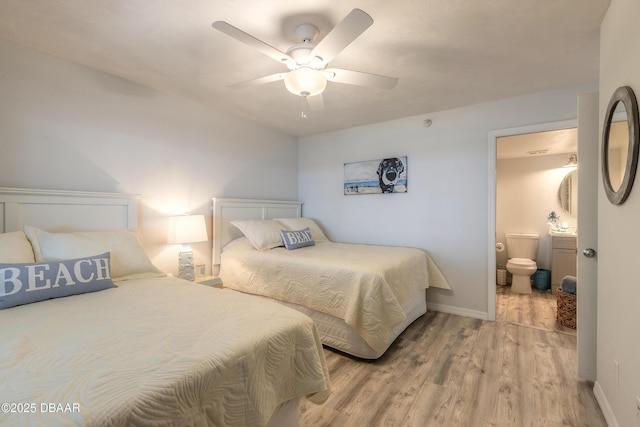 bedroom featuring ceiling fan, light hardwood / wood-style floors, and ensuite bath