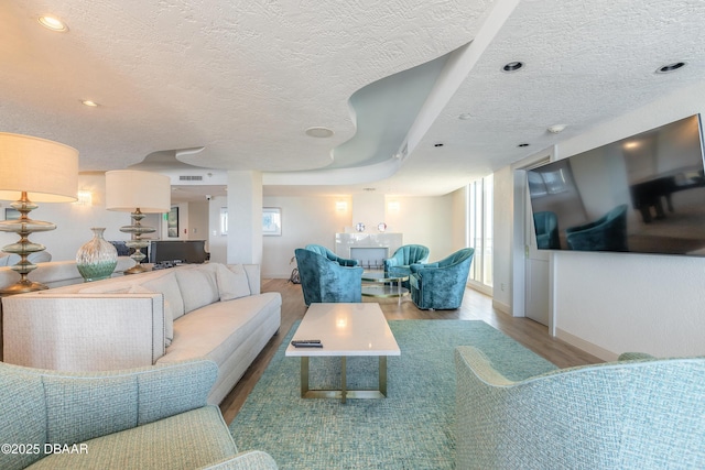 living room with hardwood / wood-style floors and a textured ceiling