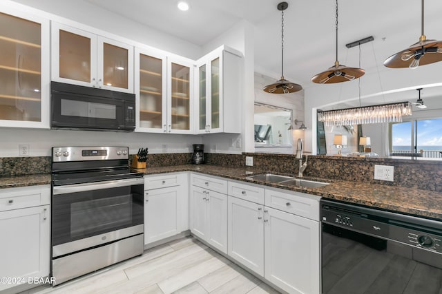 kitchen featuring black appliances, decorative light fixtures, white cabinets, and sink