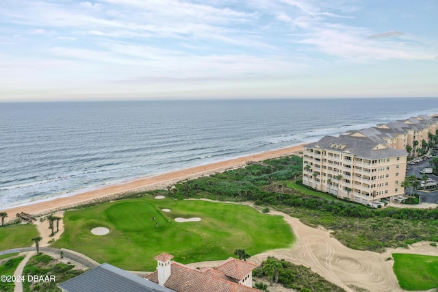 drone / aerial view with a water view and a beach view