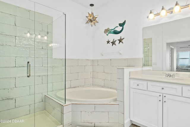 bathroom with vanity and independent shower and bath