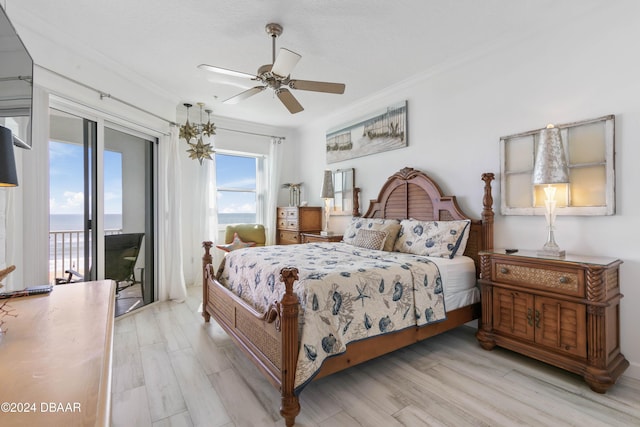 bedroom with access to exterior, light wood-type flooring, a water view, and ceiling fan