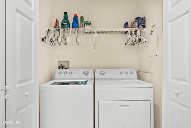 clothes washing area with washing machine and dryer