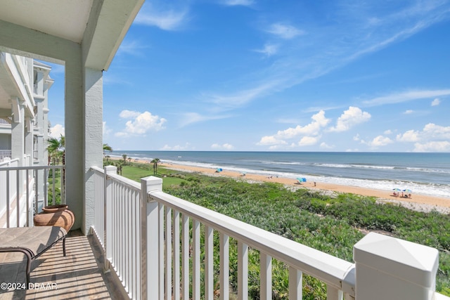 balcony with a view of the beach and a water view